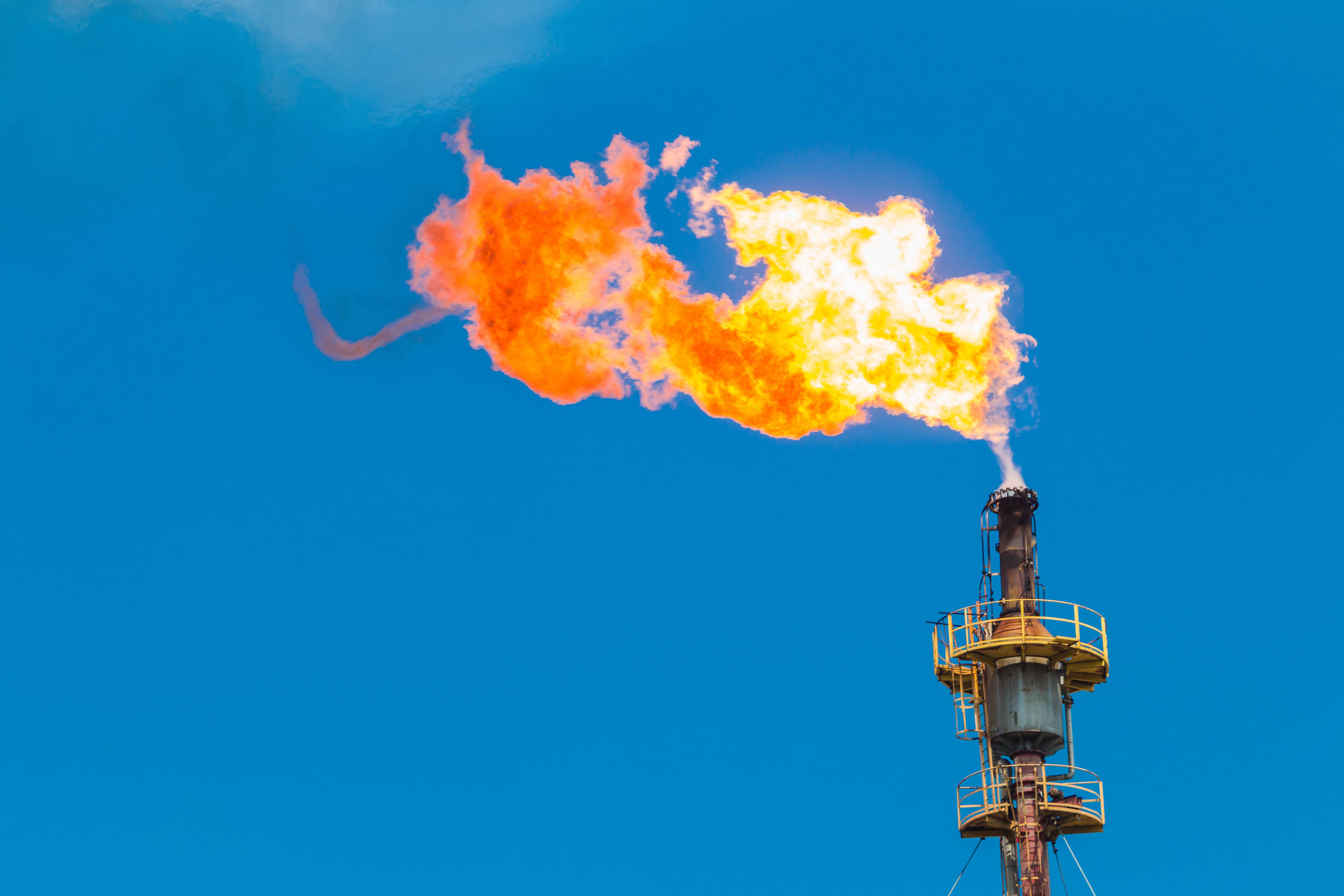 gas flare against blue sky